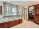 Bathroom features a large tub, a glass enclosed shower and view to the bedroom at 19748 E Pinewood Dr, Aurora, CO 80016