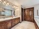 Bathroom boasts double sinks, vanity, wooden cabinets and large closet and access to bath tub at 19748 E Pinewood Dr, Aurora, CO 80016