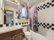 Bathroom features a tub with a shower, a sink, and Paris-themed wallpaper and shower curtain at 19748 E Pinewood Dr, Aurora, CO 80016