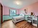 Charming bedroom with pink and blue walls features hardwood floors and a white vanity with a round mirror at 19748 E Pinewood Dr, Aurora, CO 80016