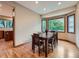 Dining room with natural light, hardwood floors, and a view of the green yard at 19748 E Pinewood Dr, Aurora, CO 80016