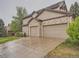Spacious two-car garage with an extended driveway, perfect for parking multiple vehicles at 19748 E Pinewood Dr, Aurora, CO 80016
