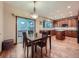 View of the kitchen and dining area, featuring hardwood floors, natural light, and a sliding glass door at 19748 E Pinewood Dr, Aurora, CO 80016
