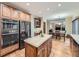 Open kitchen layout with stainless steel appliances and a center island, perfect for cooking at 19748 E Pinewood Dr, Aurora, CO 80016