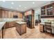 Well-appointed kitchen featuring custom cabinetry, a center island, and stainless steel appliances at 19748 E Pinewood Dr, Aurora, CO 80016