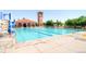 Community swimming pool and deck with seating and shade structures on a sunny day at 19748 E Pinewood Dr, Aurora, CO 80016