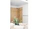 Tiled bathtub/shower combination with a showerhead, towel bar, and plant reflecting in the mirror at 17200 Waterhouse Cir # D, Parker, CO 80134