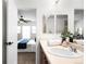 Bright bathroom has a wooden vanity with sink and attached Primary bedroom at 17200 Waterhouse Cir # D, Parker, CO 80134