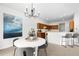 Bright dining area with a modern chandelier, a white round table, and a stylish open layout at 17200 Waterhouse Cir # D, Parker, CO 80134