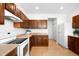 Bright kitchen with stainless steel appliances, tile floors, and wooden cabinets at 17200 Waterhouse Cir # D, Parker, CO 80134