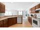 Bright kitchen features wooden cabinetry, stainless steel appliances, and white dishwasher at 17200 Waterhouse Cir # D, Parker, CO 80134