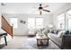 Bright living room with large windows, neutral décor, and a cozy seating area at 17200 Waterhouse Cir # D, Parker, CO 80134