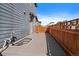 Back deck of home features gray flooring and a wood fence that surrounds the property for privacy at 6805 Canosa St, Denver, CO 80221