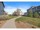Beautifully landscaped common area with grassy lawns, walking path, and a covered gazebo at 6805 Canosa St, Denver, CO 80221