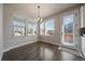Inviting dining area features hardwood floors, modern light fixture, and access to the outdoors at 6805 Canosa St, Denver, CO 80221