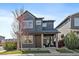 Two story house showcasing a well manicured front yard and charming porch at 6805 Canosa St, Denver, CO 80221