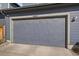 Garage door showcasing the address number 6805 of the house and outdoor lighting at 6805 Canosa St, Denver, CO 80221
