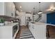 Modern kitchen with stainless steel appliances, an island with seating, and sleek finishes at 6805 Canosa St, Denver, CO 80221