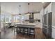 Spacious kitchen featuring a large island with seating, stainless steel refrigerator at 6805 Canosa St, Denver, CO 80221