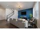 Contemporary living room with blue accent wall, modern decor, and lots of natural light at 6805 Canosa St, Denver, CO 80221