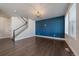 Bright, open-concept living room with hardwood floors and a modern light fixture at 6805 Canosa St, Denver, CO 80221