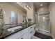 Luxurious main bathroom featuring double vanity, granite countertops, and glass-enclosed shower at 6805 Canosa St, Denver, CO 80221