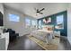 Comfortable main bedroom featuring ample natural light, stylish decor, and ceiling fan at 6805 Canosa St, Denver, CO 80221