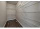 Spacious walk-in closet with ample shelving and hardwood floors for optimal storage at 6805 Canosa St, Denver, CO 80221