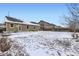 Snow covered backyard featuring a lawn, fence and exterior of home at 1945 Basil St, Strasburg, CO 80136