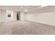 Large finished basement with carpet and multiple rooms for storage or entertaining at 1945 Basil St, Strasburg, CO 80136