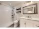 Bathroom featuring a white vanity, modern fixtures, and shower at 1945 Basil St, Strasburg, CO 80136