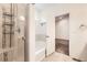 Bright bathroom featuring a tiled shower with glass door and convenient towel rack at 1945 Basil St, Strasburg, CO 80136