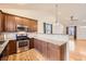Modern kitchen featuring granite countertops, stainless steel appliances, and wood cabinets at 1945 Basil St, Strasburg, CO 80136