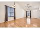 Living room with hardwood floors, abundant natural light, ceiling fan and neutral color palette at 1945 Basil St, Strasburg, CO 80136