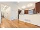 View of the living room highlighting wood flooring, an open layout, and recessed lighting at 1945 Basil St, Strasburg, CO 80136