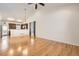 Spacious living room featuring wood floors, neutral walls, and an open concept design at 1945 Basil St, Strasburg, CO 80136