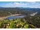 Majestic aerial view showcasing the lake, golf course, mountains, and surrounding natural beauty at 2356 Hiwan Dr # 40, Evergreen, CO 80439