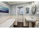Bright bathroom featuring a pedestal sink and a clawfoot tub with stylish decor at 2356 Hiwan Dr # 40, Evergreen, CO 80439