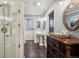 Bathroom featuring a walk-in shower, vintage dresser, and pedestal sink at 2356 Hiwan Dr # 40, Evergreen, CO 80439