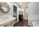 Bathroom featuring dual pedestal sinks, a clawfoot tub and an ensuite toilet at 2356 Hiwan Dr # 40, Evergreen, CO 80439