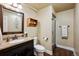 Well-lit bathroom with a dark wood vanity, neutral walls, and a glass-enclosed walk-in shower at 2356 Hiwan Dr # 40, Evergreen, CO 80439
