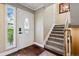 Welcoming foyer with hardwood floors, elegant front door, and staircase at 2356 Hiwan Dr # 40, Evergreen, CO 80439