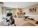 Home gym equipped with rowing machine, weights, and a wall-mounted TV for a complete fitness experience at 2356 Hiwan Dr # 40, Evergreen, CO 80439
