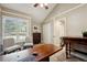 Bright office space featuring a vaulted ceiling, shuttered windows, and traditional wood furnishings at 2356 Hiwan Dr # 40, Evergreen, CO 80439