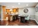 Open kitchen with wood cabinets, breakfast bar and adjacent dining area with stylish finishes at 2356 Hiwan Dr # 40, Evergreen, CO 80439