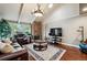 Cozy living room with a stone fireplace, vaulted ceilings, and comfortable leather furniture at 2356 Hiwan Dr # 40, Evergreen, CO 80439