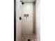Walk-in shower features modern fixtures, mosaic stone accents, and tiled walls for a spa-like experience at 2356 Hiwan Dr # 40, Evergreen, CO 80439