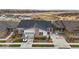 Beautiful home aerial showing the front yard landscaping, the driveway, and the surrounding neighborhood at 2020 Sagerock Dr, Castle Pines, CO 80108