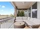 Covered balcony with neutral furniture provides a relaxing outdoor living space with scenic views at 2020 Sagerock Dr, Castle Pines, CO 80108