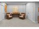 Basement showcases two wicker chairs, a wood table with decor, and neutral walls and carpet for versatile space at 2020 Sagerock Dr, Castle Pines, CO 80108